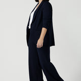 Size 10 women wearing a Navy Marit blazer with Scuba crepe and collar. It has functional patch pockets and tailored shawl collar. Stylish corporate casual wear for women. Made in Australia size 8 - 24.