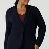 Size 16 women wearing a Navy Marit blazer with Scuba crepe and collar. It has functional patch pockets and tailored shawl collar. Stylish corporate casual wear for women. Made in Australia size 8 - 24.