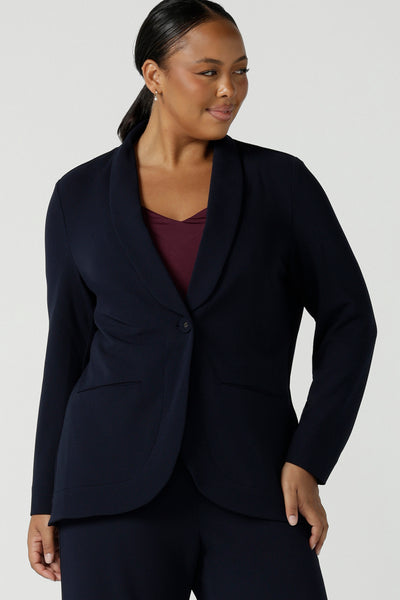 Size 16 women wearing a Navy Marit blazer with Scuba crepe and collar. It has functional patch pockets and tailored shawl collar. Stylish corporate casual wear for women. Made in Australia size 8 - 24.