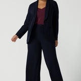 Size 16 women wearing a Navy Marit blazer with Scuba crepe and collar. It has functional patch pockets and tailored shawl collar. Stylish corporate casual wear for women. Made in Australia size 8 - 24.