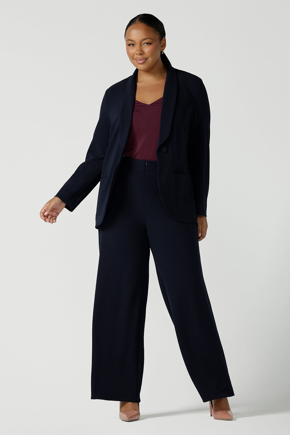 Size 16 women wearing a Navy Marit blazer with Scuba crepe and collar. It has functional patch pockets and tailored shawl collar. Stylish corporate casual wear for women. Made in Australia size 8 - 24.