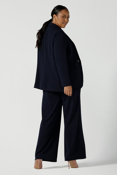 Back view of a size 16 women wearing a Navy Marit blazer with Scuba crepe and collar. It has functional patch pockets and tailored shawl collar. Stylish corporate casual wear for women. Made in Australia size 8 - 24.