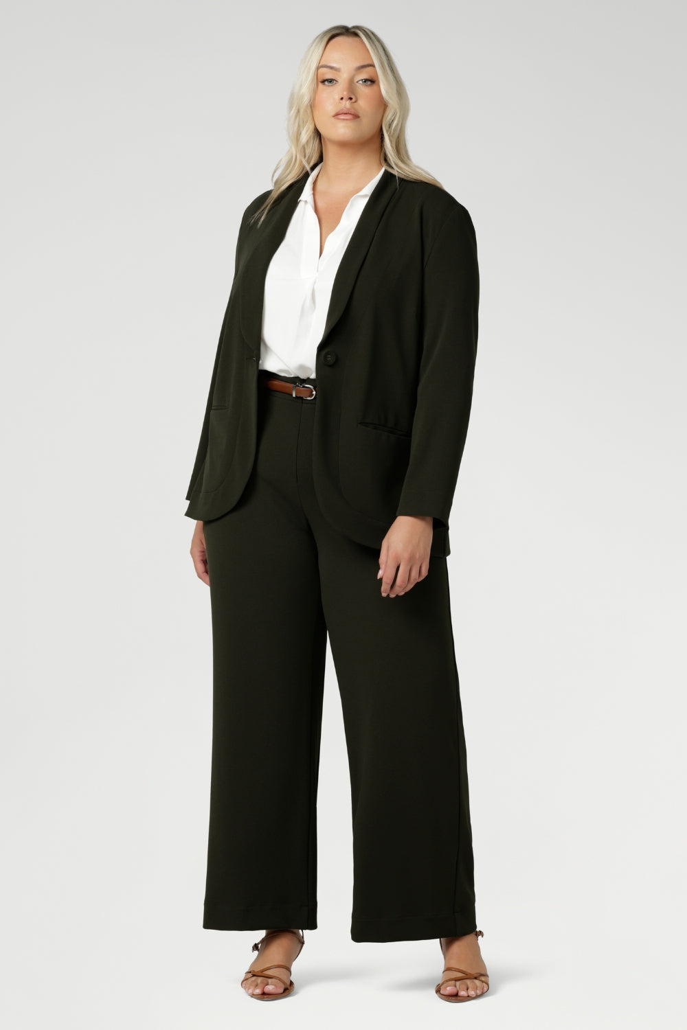 Woman's blazer will have you looking stylish in all corporate and casual occasions. Woman's workwear suiting made in Australia in sizes 8-24 from scuba crepe fabric. Size 10 woman wears her Olive Blazer with matching workwear wide leg pants