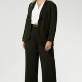 Woman's blazer will have you looking stylish in all corporate and casual occasions. Woman's workwear suiting made in Australia in sizes 8-24 from scuba crepe fabric. Size 10 woman wears her Olive Blazer with matching workwear wide leg pants