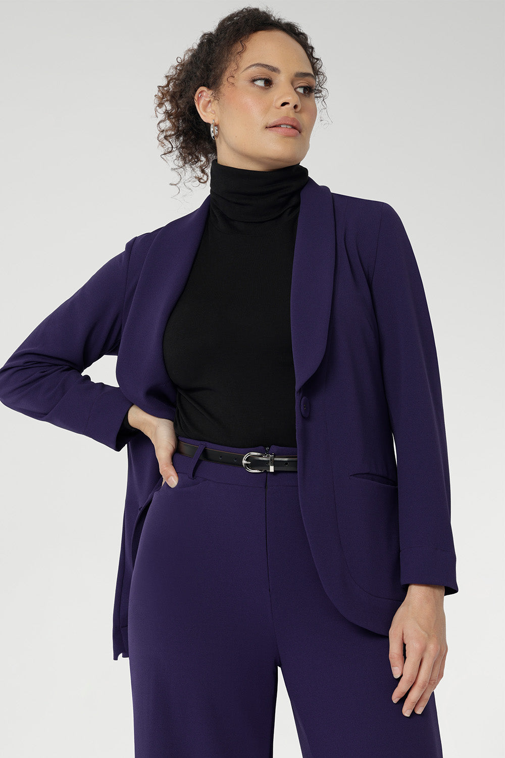 Redefine power dressing with the Merit Blazer, a modern classic crafted from our premium Scuba Crepe fabric for a sleek, structured fit with just the right amount of stretch. This expertly tailored jacket delivers timeless sophistication with a contemporary edge, featuring a sharp tuxedo-style shawl collar, a button-up front, and full-length sleeves with foldable cuffs for versatile styling.