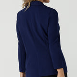 Back view of a size 10 woman wears the Merit Blazer in Sailor Scuba crepe fabric. A softly tailored blazer with lapel collar and full length sleeves. Button front and pockets. Made in Australia for women size 8-24.