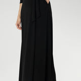 Offered in a size-inclusive range from 8 to 24, this black wrap dress is tailored to complement every shape and style. Refined, effortless, and made just for you. A custom made dress that goes everywhere and works for everything.
