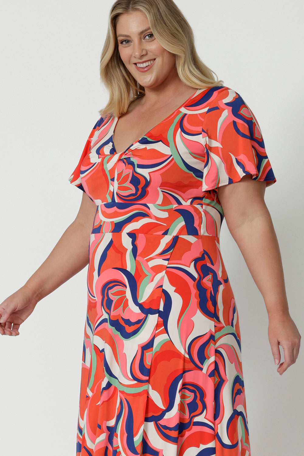 Detail side view of a good summer maxi dress for plus size women, this printed jersey dress has a twist front bodice and flutter sleeves. A dress for cruise holidays and resort style, this maxi dress is easy-care and crease-resistant. Made in Australian by Australian and New Zealand women's curve clothing brand, Leina & Fleur, shop their cruise wear fashions online in sizes 8 to 24.