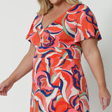 Detail side view of a good summer maxi dress for plus size women, this printed jersey dress has a twist front bodice and flutter sleeves. A dress for cruise holidays and resort style, this maxi dress is easy-care and crease-resistant. Made in Australian by Australian and New Zealand women's curve clothing brand, Leina & Fleur, shop their cruise wear fashions online in sizes 8 to 24.