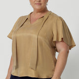 V-neckline blouse with delicate neckties adds a touch of feminine elegance, while allowing you to adjust the fit for added comfort and style. Workwear blouse also has short flutter sleeves with slits on the shoulders, that add a modern, airy feel to the blouse, giving it a subtle yet playful look.