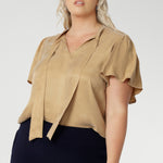 V-neckline blouse with delicate neckties adds a touch of feminine elegance, while allowing you to adjust the fit for added comfort and style. Workwear blouse also has short flutter sleeves with slits on the shoulders, that add a modern, airy feel to the blouse, giving it a subtle yet playful look.