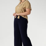 Plus size woman wears semi-fitted design of the Michael Shirt. Tailored yet relaxed feel, this blouse has the right amount of structure without feeling too tight. The V-neckline with delicate neckties adds a touch of feminine elegance, while allowing you to adjust the fit for added comfort and style. The short flutter sleeves, with slits on the shoulders, add a modern, airy feel to the blouse, perfect for this time of year. Available in sizes 8-24.