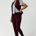Serene Ice Blue & Deep Wine. This blouse drapes beautifully on the body, creating a flattering and luminous effect. Though the fabric has no stretch, its elegant drape moves gracefully with you, adding a touch of elevated style to any occasion. Size 10 model wears her Ice Blue blouse with wine coloured suiting vest and tapered pants for a casual take on a feminine blouse.