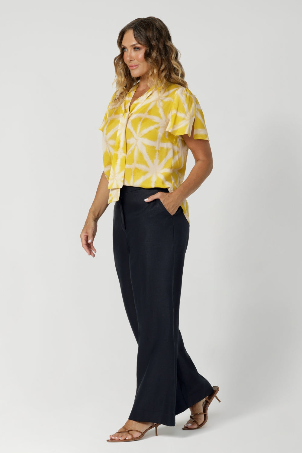 Size 12 model wears a perfectly suited top for a woman on the go, the shirt transitions effortlessly from work to after-hours events, offering both style and functionality. Proudly made in Australia, designed with Australian and New Zealand women in mind, and stocked in a wide range of sizes from 8 to 24 to ensure a perfect fit for every woman. 