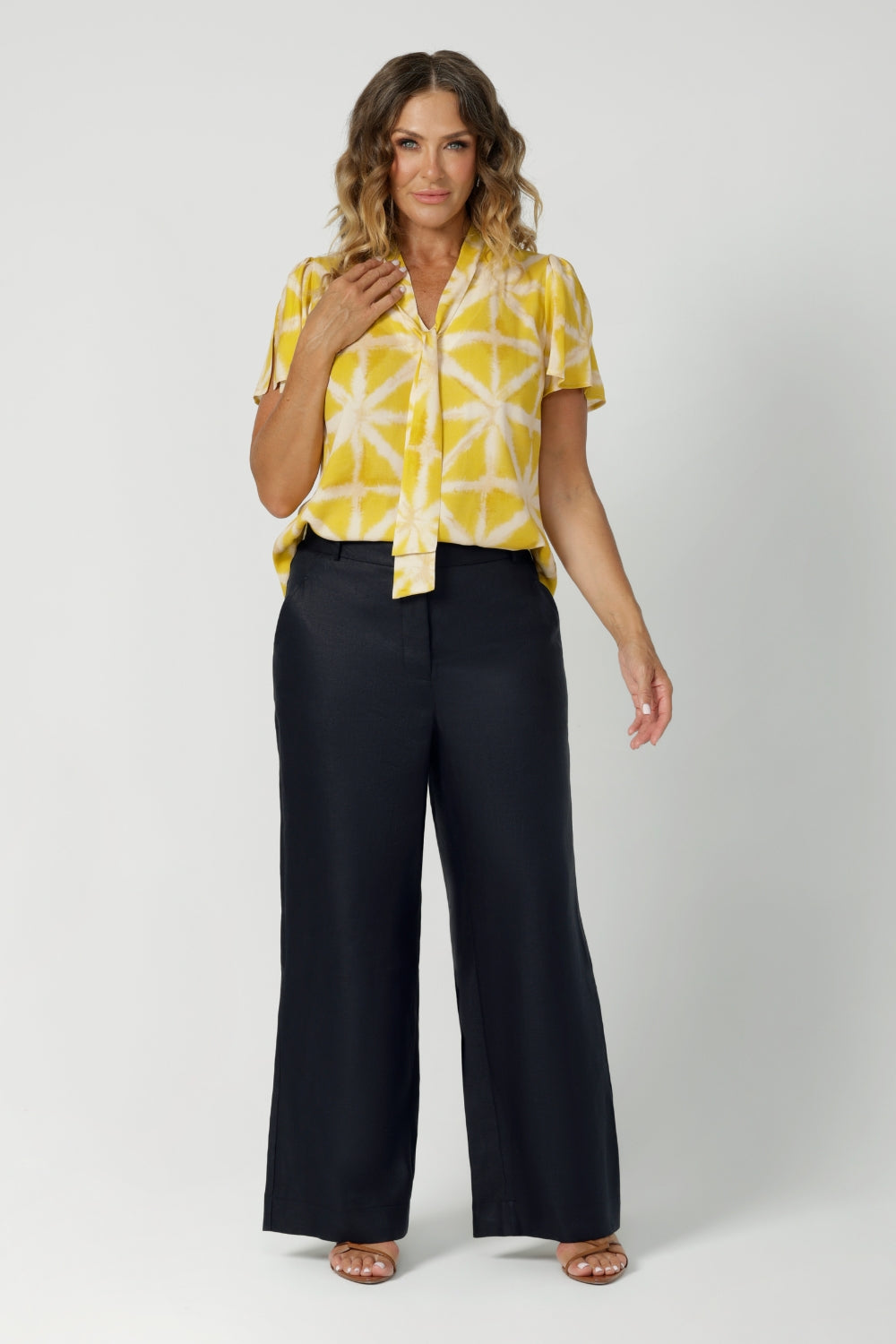 The shirt combines eco-conscious materials with thoughtful design, making it a staple for both work and play. Unique neckline with tie can be done up for added coverage or left undone for a more relaxed, open look, allowing you to customise your style. Shop this look in sizes 8-24.