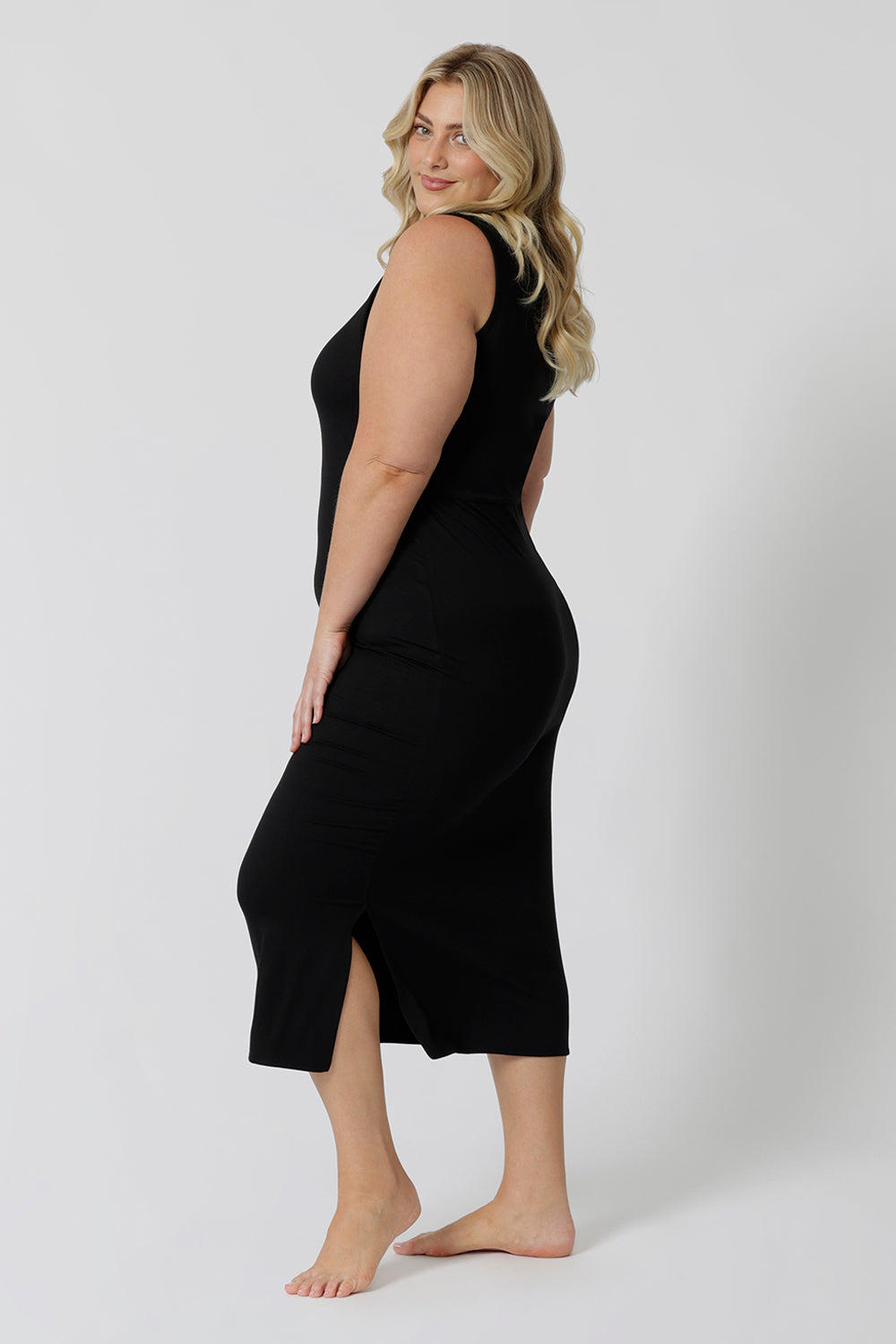 Side view of a midi dress that works as a nightdress and as loungewear. Shown on a size 18 woman, this slim-fit, plus size midi-dress in bamboo jersey is breathable and thermo-regulating. A good dress for night sweats and hot flushes, wear this as a summer dress for warm summer days. Shop nightdresses online in sizes 8 to 24 at L&F Australia.