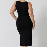 Back view of a midi dress that works as a nightdress and as loungewear. Shown on a size 18 woman, this slim-fit, plus size midi-dress in black bamboo jersey is breathable and thermo-regulating. A good dress for night sweats and hot flushes, wear this black dress as a summer dress for warm summer days. Shop nightdresses online in sizes 8 to 24 at L&F Australia.