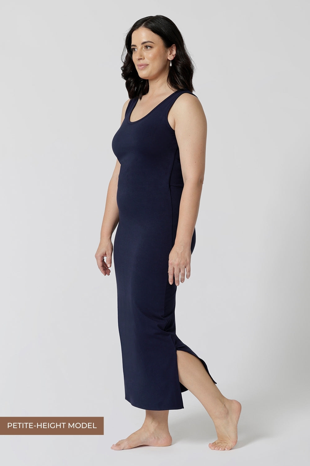 Side view of a navy blue lounge dress that works as a nightdress and as loungewear. Shown for petite women, this slim-fit, plus size midi-dress in navy blue bamboo jersey is breathable and thermo-regulating. A good dress for night sweats and hot flushes, wear this as a summer dress for warm summer days. Shop nightdresses in women's clothes label, L&F's new loungewear and sleepwear range online in sizes 8 to 24.