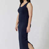 Side view of a navy blue lounge dress that works as a nightdress and as loungewear. Shown for petite women, this slim-fit, plus size midi-dress in navy blue bamboo jersey is breathable and thermo-regulating. A good dress for night sweats and hot flushes, wear this as a summer dress for warm summer days. Shop nightdresses in women's clothes label, L&F's new loungewear and sleepwear range online in sizes 8 to 24.