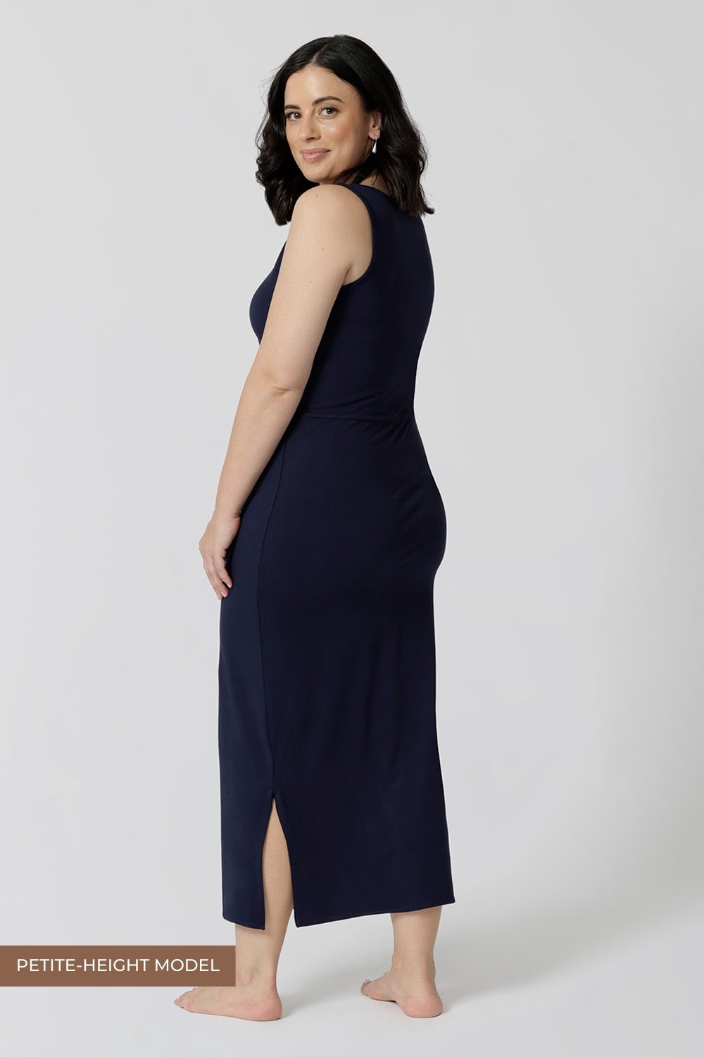 Back view of a  midi dress that works as a nightdress and as loungewear. Shown for petite women, this slim-fit midi-dress in navy blue bamboo jersey is breathable and thermo-regulating. A good dress for night sweats and hot flushes, wear this as a summer dress for warm summer days. Shop nightdresses in women's clothes brand, L&F's new loungewear and sleepwear range online in sizes 8 to 24.