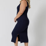 Side view of a midi dress that works as a nightdress and as loungewear. Shown on a size 18 woman, this slim-fit, plus size midi-dress in navy blue bamboo jersey is breathable and thermo-regulating. A good dress for night sweats and hot flushes, wear this as a summer dress for warm summer days. Shop nightdresses in women's clothes brand, L&F's new loungewear and sleepwear range online in sizes 8 to 24.