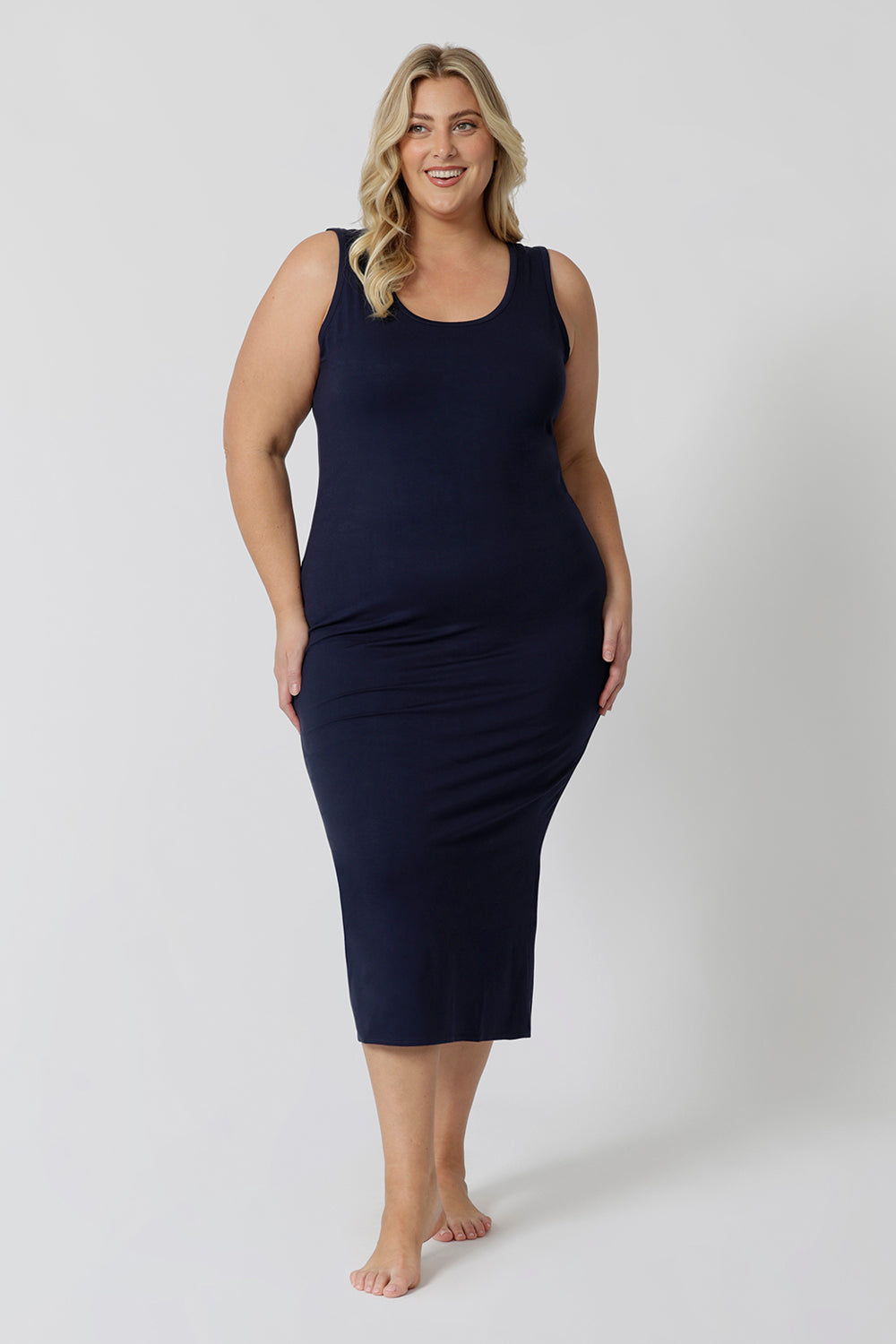 A midi dress that works as a nightdress and as loungewear. Shown on a size 18 woman, this slim-fit, plus size midi-dress in navy blue bamboo jersey is breathable and thermo-regulating. A good dress for night sweats and hot flushes, wear this as a summer dress for warm summer days. Shop nightdresses in women's clothes brand, L&F's new loungewear and sleepwear range online in sizes 8 to 24.