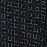 The Midnight Mosaic print is crafted on a dry touch jersey base in Navy, with geometric details in shades of green and grey. The fabric has a soft stretch. Image swatch of Midnight Mosaic print used to create Australian made woman's workwear clothing.