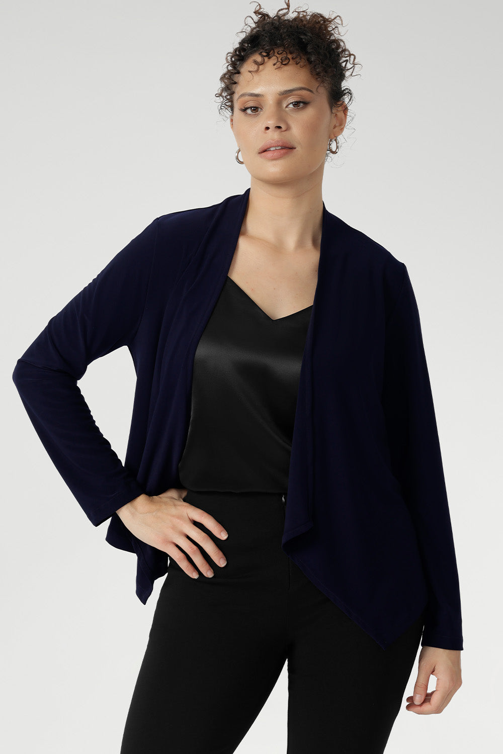 Softly tailored with a refined waterfall collar and an open front design, Mikey offers a polished, jacket-like silhouette that effortlessly carries you from the workday into evening events.