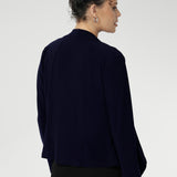 Back darts create a flattering shape, while the angled front hemline and full-length sleeves add a modern, sophisticated edge. Designed for both versatility and style, this timeless piece is proudly made in Australia and perfect for year-round wear.