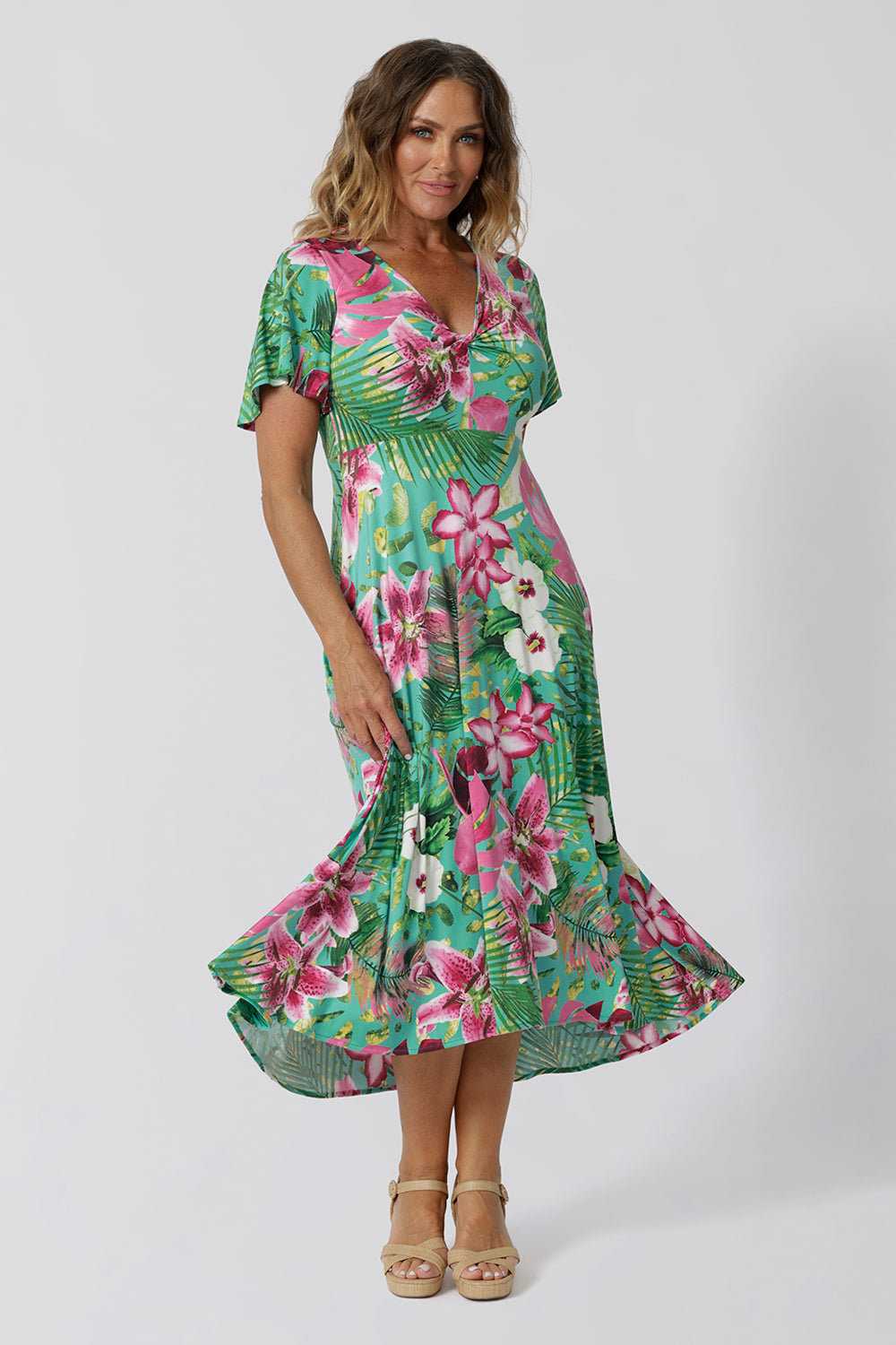 This floral high-low hem midi dress is the perfect blend of style and comfort, designed for a summer-ready, resort-ready look. Crafted from soft, slinky jersey fabric, it drapes effortlessly over the body, offering both fluid movement and a flattering fit. The midi length adds a touch of elegance, while the high-low hem gives it a modern, breezy feel. Ideal for beachside resorts or casual summer outings. Made in Australia. Sizes 8-24.