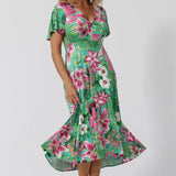 This floral high-low hem midi dress is the perfect blend of style and comfort, designed for a summer-ready, resort-ready look. Crafted from soft, slinky jersey fabric, it drapes effortlessly over the body, offering both fluid movement and a flattering fit. The midi length adds a touch of elegance, while the high-low hem gives it a modern, breezy feel. Ideal for beachside resorts or casual summer outings. Made in Australia. Sizes 8-24.