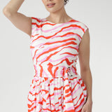 The vibrant abstract print combines pink and red tones on a soft vanilla base, bringing playful energy to warm days. Finished with a coordinating belt to define the waist. Made in Australia with integrity.
