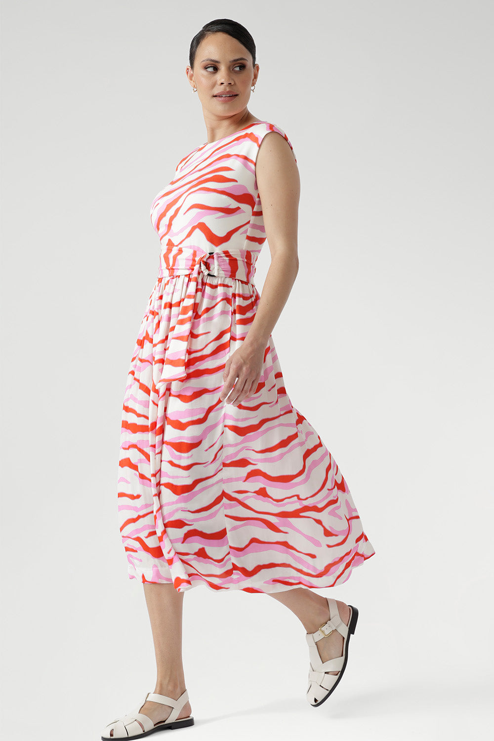 Crafted from breathable natural fibres, the Misha Dress in Pink Tang with Belt blends texture and movement for effortless summer style.