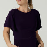 Close up of the Monique dress in Amethyst. Jersey dress with flutter sleeve and rounded neckline. Full circle skirt and pockets. Made in Australia for women size 8 - 24.