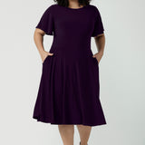 Monique dress in Amethyst. Jersey dress with flutter sleeve and rounded neckline. Full circle skirt and pockets. Made in Australia for women size 8 - 24.