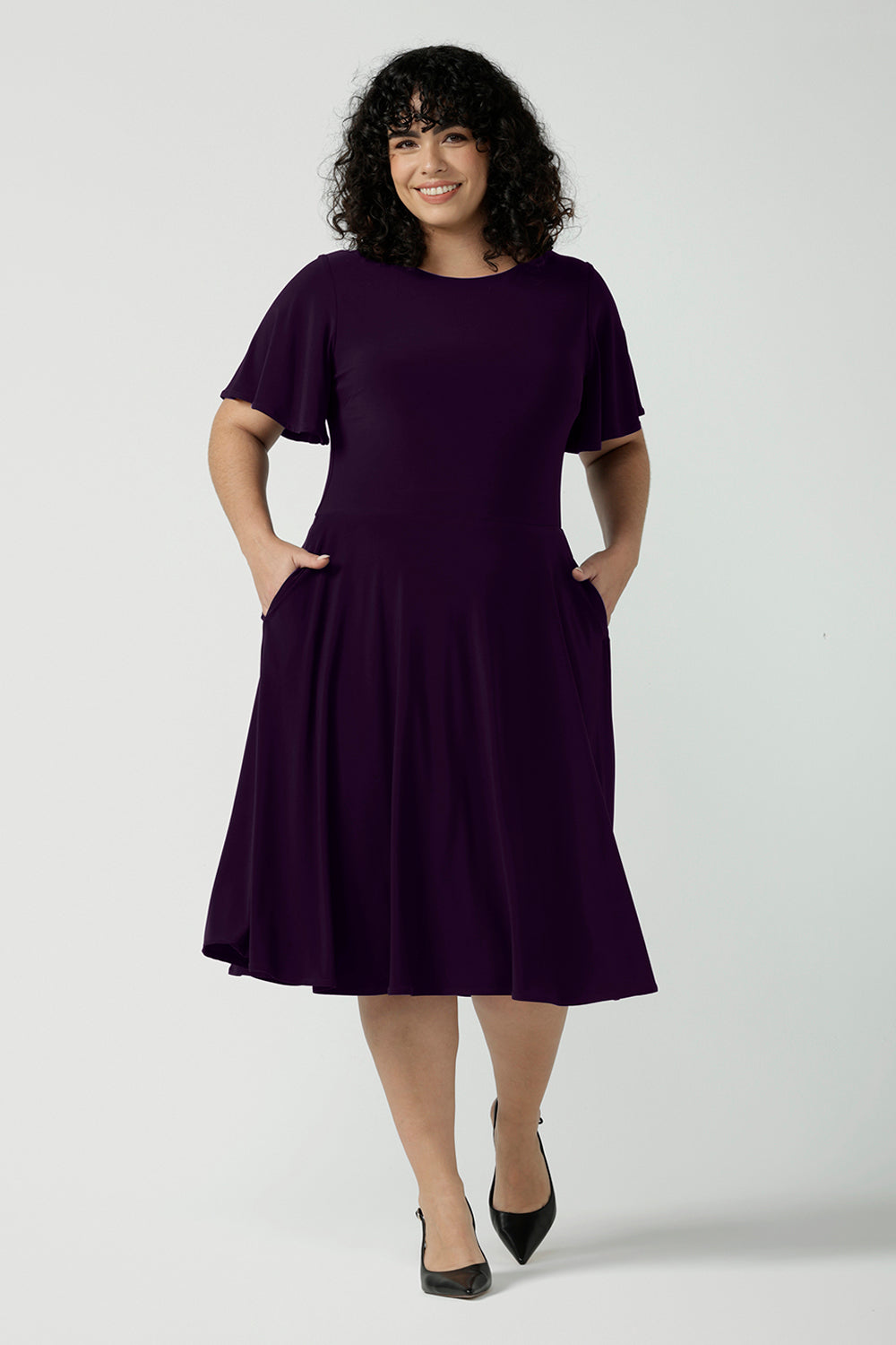 Monique dress in Amethyst. Jersey dress with flutter sleeve and rounded neckline. Full circle skirt and pockets. Made in Australia for women size 8 - 24.