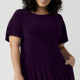 Monique dress in Amethyst. Jersey dress with flutter sleeve and rounded neckline. Full circle skirt and pockets. Made in Australia for women size 8 - 24.