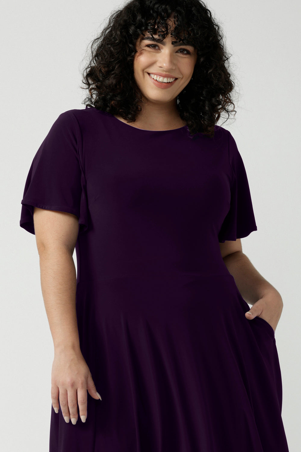Monique dress in Amethyst. Jersey dress with flutter sleeve and rounded neckline. Full circle skirt and pockets. Made in Australia for women size 8 - 24.