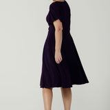 Back view of the Monique dress in Amethyst. Jersey dress with flutter sleeve and rounded neckline. Full circle skirt and pockets. Made in Australia for women size 8 - 24.