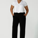 Tall woman curvy size 16 model wears Monroe Tall pants. Great work pants for tall women. Comfortable work pants in black jersey. Made in Australia size 8 - 24.