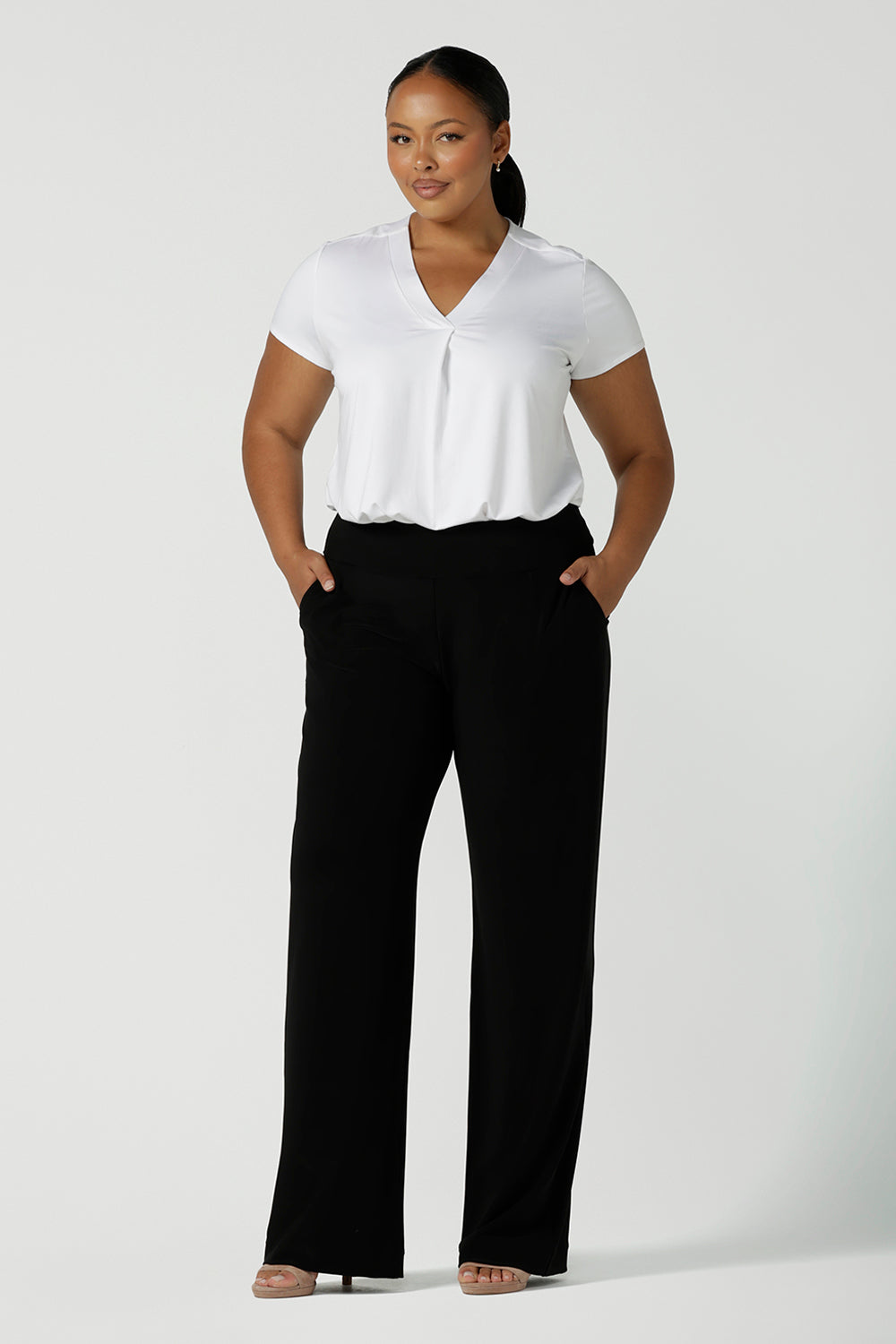 Tall woman curvy size 16 model wears Monroe Tall pants. Great work pants for tall women. Comfortable work pants in black jersey. Made in Australia size 8 - 24.
