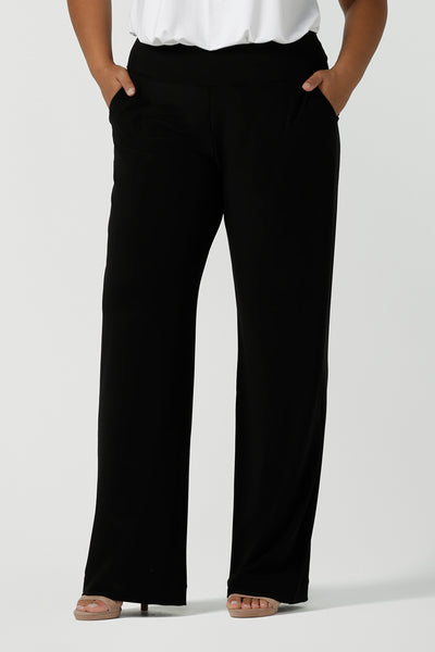 Close up of a tall woman curvy size 16 model wears Monroe Tall pants. Great work pants for tall women. Comfortable work pants in black jersey. Made in Australia size 8 - 24.