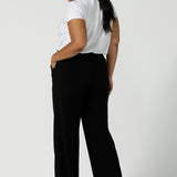 Back view of a tall woman curvy size 16 model wears Monroe Tall pants. Great work pants for tall women. Comfortable work pants in black jersey. Made in Australia size 8 - 24.