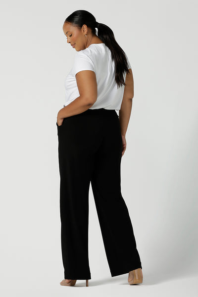 Back view of a tall woman curvy size 16 model wears Monroe Tall pants. Great work pants for tall women. Comfortable work pants in black jersey. Made in Australia size 8 - 24.