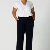 Tall woman curvy size 16 model wears Monroe Tall pants in navy. Great work pants for tall women. Comfortable work pants in navy jersey. Made in Australia size 8 - 24.