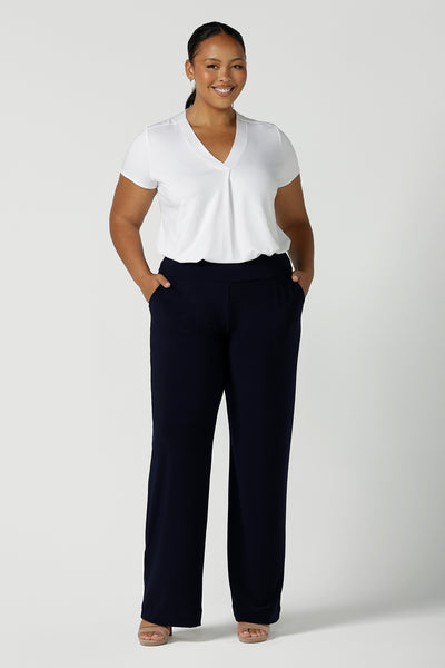 Tall woman curvy size 16 model wears Monroe Tall pants in navy. Great work pants for tall women. Comfortable work pants in navy jersey. Made in Australia size 8 - 24.