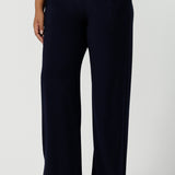 Close up of a tall woman curvy size 16 model wears Monroe Tall pants in navy. Great work pants for tall women. Comfortable work pants in navy jersey. Made in Australia size 8 - 24.