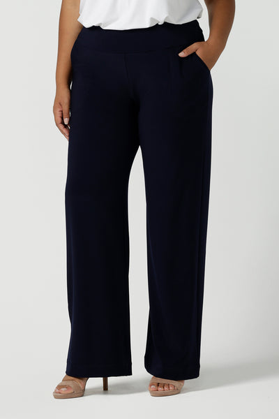 Close up of a tall woman curvy size 16 model wears Monroe Tall pants in navy. Great work pants for tall women. Comfortable work pants in navy jersey. Made in Australia size 8 - 24.