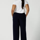 Back view of a tall woman curvy size 16 model wears Monroe Tall pants in navy. Great work pants for tall women. Comfortable work pants in navy jersey. Made in Australia size 8 - 24.