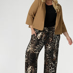 Plus size woman wears her Monroe Pants in Panthera in the long length withblack shirt, layered under a caramel ponte jacket. Creating an everyday stylish look that makes a statement. 
